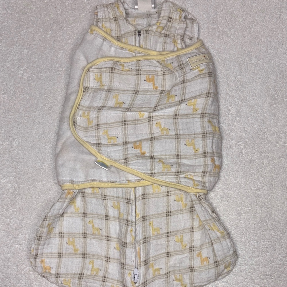 Halo SleepSack Swaddle in Soft Yellow and White muslin giraffe print newborn